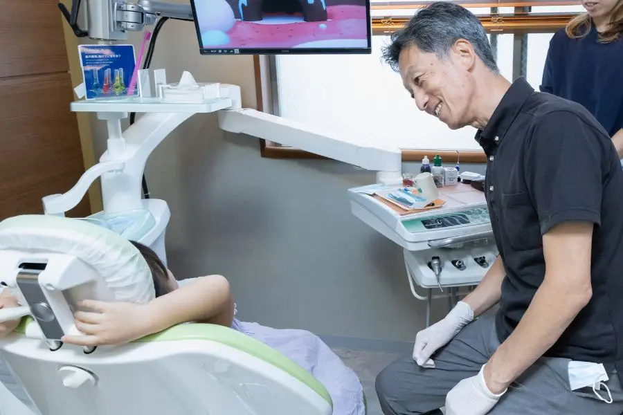 小児の患者と笑顔で話をする院長